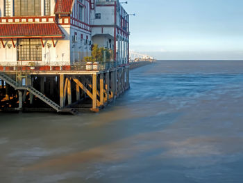 Bridge over sea against sky