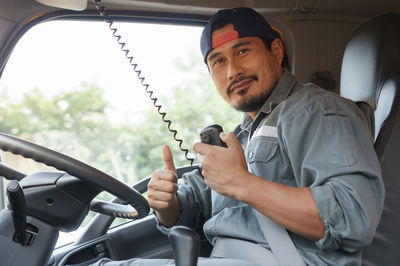 Young man sitting in car