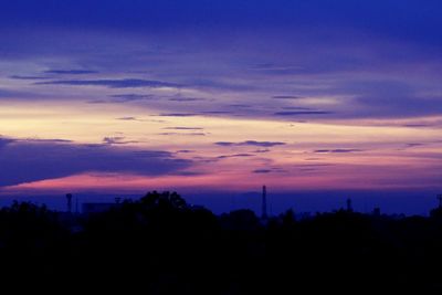 Silhouette trees against sky during sunset