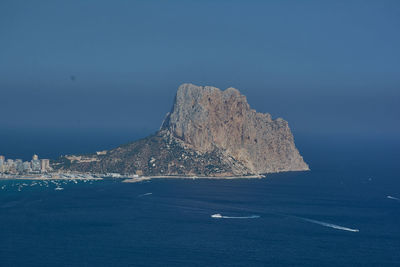 Ship sailing on sea against clear sky