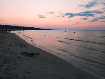 Scenic view of beach against sky during sunset