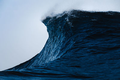 Close-up of sea against clear blue sky