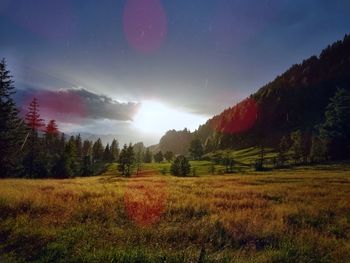 Scenic view of field and mountains against sky