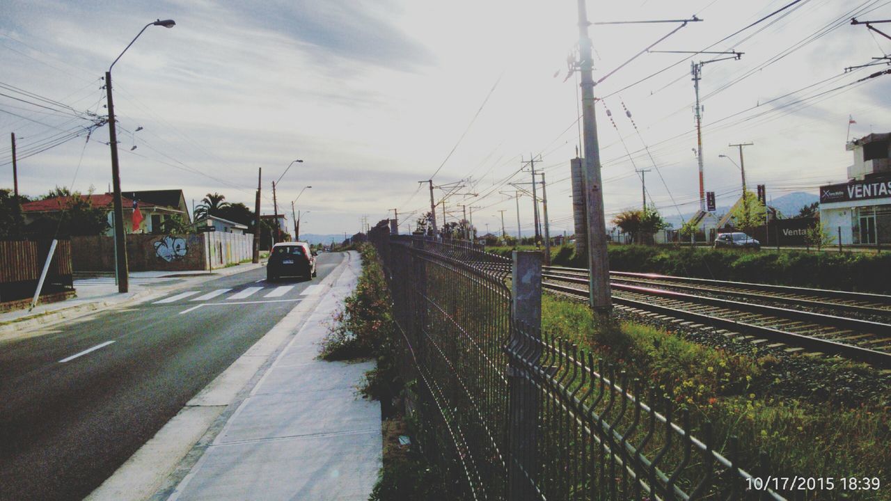 transportation, railroad track, power line, electricity pylon, sky, rail transportation, the way forward, mode of transport, power supply, diminishing perspective, cable, electricity, public transportation, vanishing point, cloud - sky, railroad station platform, power cable, road, land vehicle, railway track