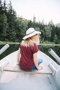 Rear view of a young woman in boat
