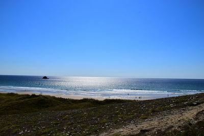 Scenic view of sea against clear blue sky