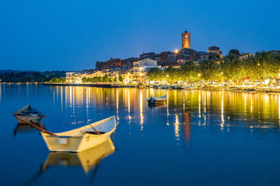 Nightview of the ancient village of marta, on the shore of bolsena lake in lazio, italy