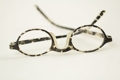 Close-up of sunglasses against white background