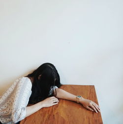 Woman with hands on table