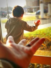 Rear view of boy holding ice cream