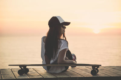 Beautiful young girl with her skateboard