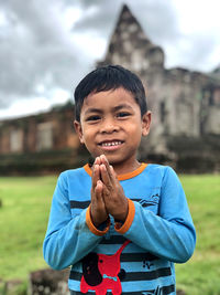 Portrait of smiling boy standing outdoors