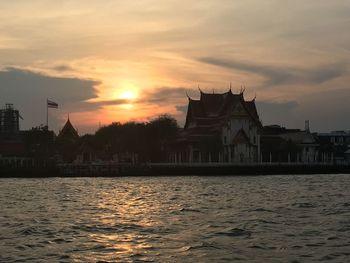 Scenic view of river against sky during sunset