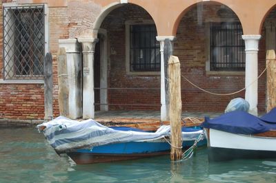 Man relaxing on boat against building