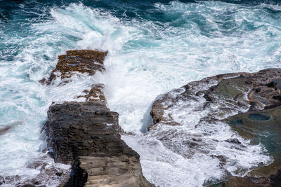 Hi angle view of waves splashing on rocks at stairs of the great sepent , dominica.