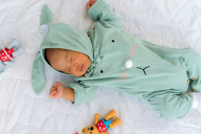 High angle view of baby boy sleeping on bed