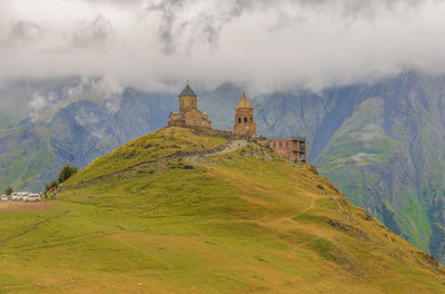 Scenic view of historic building against cloudy sky