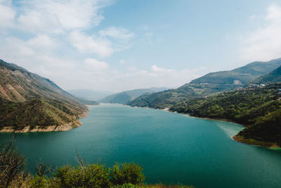 Scenic view of lake and mountains against sky