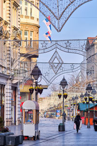 People on city street with buildings in background