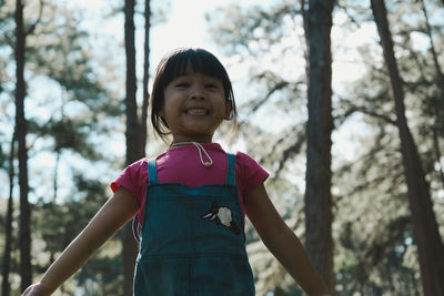 Low angle view of girl standing in park