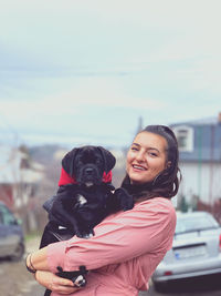 Portrait of smiling woman with dog