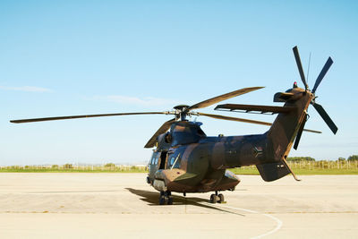 Low angle view of helicopter against clear sky