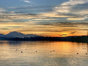 Scenic view of lake against sky during sunset