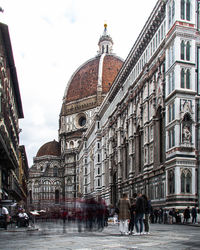 Group of people in front of buildings in city