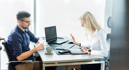 Businesswoman using laptop at office