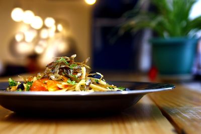 Close-up of meal served in plate on wooden table