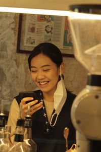 Portrait of young woman sitting at home