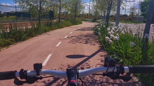 Bicycle parked by road in city