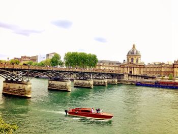 Boats in river with buildings in background