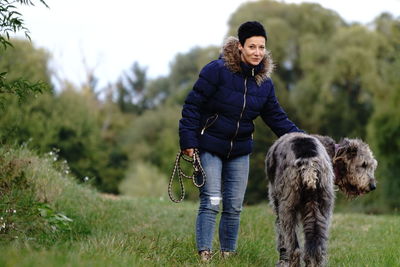 Young woman walking dog