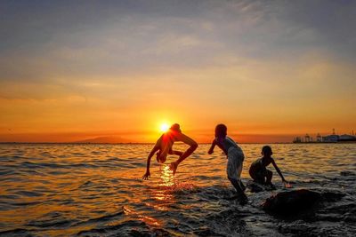 People on beach at sunset