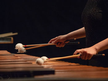 Cropped image of woman playing musical instrument