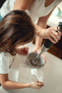 Midsection of woman holding camera