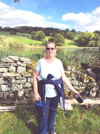 Portrait of smiling man standing on field