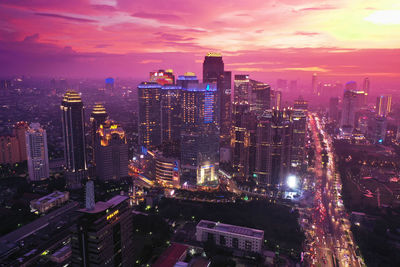 High angle view of illuminated city buildings against sky