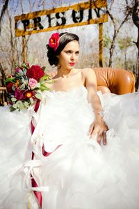 Bride looking away while sitting on chair