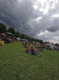 View of grassy field against cloudy sky