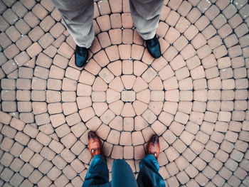 Low section of man standing on street