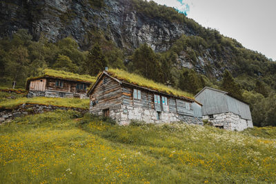 Abandoned house on field against sky