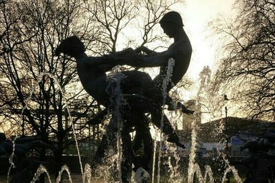 Bare trees against sky