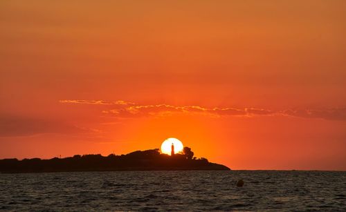 Scenic view of sea against orange sky