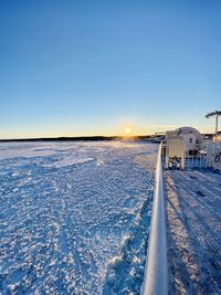 Scenic view of snow covered landscape against clear blue sky