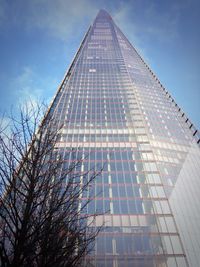 Low angle view of office building against blue sky