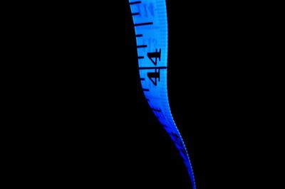 Close-up of blue light over black background