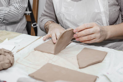 Midsection of woman working on table