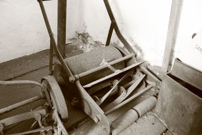 High angle view of old pipes on floor against wall